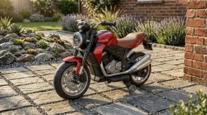 A photorealistic close-up of a laminated birch wood balance bike with a brown leather-look saddle, standing on a textured stone paver patio.