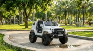 A rugged miniature white electric ride-on SUV for 3-5 year olds featuring rugged wheels and working headlights, parked on a stone-paved pathway in a sunny Vietnamese park.