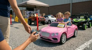 A parent holding a remote control next to a 24 volt ride on toy car on clearance.