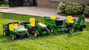A lineup of different battery-powered John Deere ride-on toys for kids, including tractors, dump trucks, and ATVs.