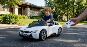 Child driving a white BMW i8 ride-on car using parent remote control outdoors.