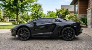 Profile view of a black 12V licensed Lamborghini Aventador ride on car showing its realistic wheels and sleek sports car profile.