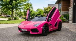 Pink licensed Lamborghini Aventador ride on toy car with its signature scissor doors fully open.