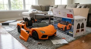 An unboxed orange Lamborghini ride-on car for kids next to its packaging box in a living room during assembly.