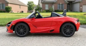 Side profile view of a red McLaren 12V ride-on car designed for children aged 3 to 6