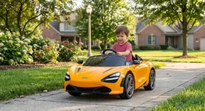 Young child driving a licensed McLaren 12V ride-on car through a neighborhood park walkway
