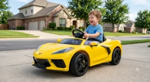 Young boy seated in a bright yellow battery-powered Corvette ride-on car for toddlers.