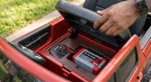 Detailed view of the 12V battery charging port location under the seat of the Ram truck ride on toy.