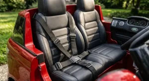 Close-up of comfortable leather seats and adjustable safety belt in a 24V Range Rover ride-on vehicle.