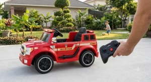 12V battery-powered fire truck ride-on car featuring a remote control for parental safety supervision.