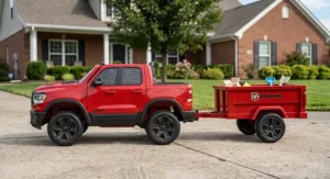 Side view of the kids Ram truck ride on toy with trailer showing the spacious cargo bed and rugged wheels.