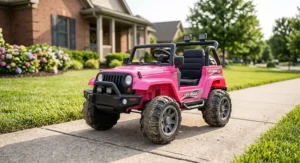 Bright pink battery powered ride on truck with rubber tires parked on a sunny sidewalk.