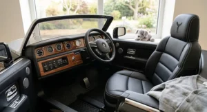 Detailed interior view of a kids electric Rolls Royce ride-on car featuring padded leather seats and realistic dashboard buttons