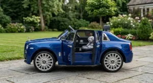 Side view profile of a blue Rolls Royce ride-on car for kids showcasing open functional side doors