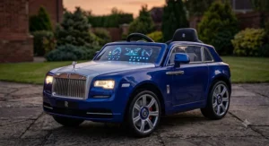 Kids electric Rolls Royce ride-on car illuminated at dusk highlighting glowing dashboard and headlights