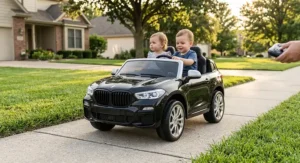 An upscale black SUV style 2 seater luxury ride on car for toddlers cruising down a neighborhood sidewalk