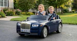 Two young siblings smiling inside a 2-seater Rolls Royce ride-on car for kids equipped with seat belts
