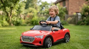 Excited toddler holding the steering wheel of a battery-powered ride-on car for 3 year old