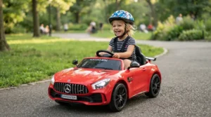 A young driver wearing a helmet while operating a high speed ride-on car for kids outdoors.
