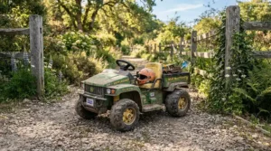 An off-road ride-on car for preteens parked on a country gravel driveway.