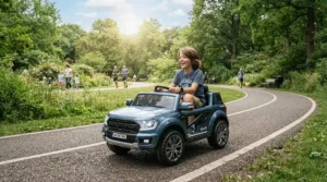 A teenager driving a ride-on car for tall 12 year old along a paved community park trail