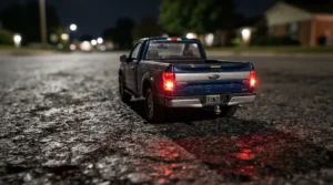 A stylish ride-on truck for 7 year old boy showing illuminated taillights in a neighborhood driveway.