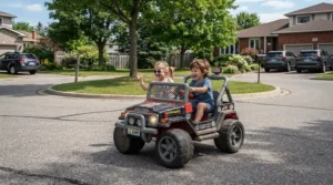 Kids steering a 24v two seater ride on car for kids 3 to 8 years around a neighborhood cul-de-sac