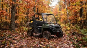 An off-road electric vehicle for adults parked along a shaded autumn woodland path.
